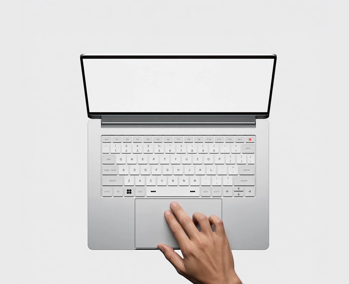 A laptop seen from directly above, its screen blank, with a hand resting on the trackpad.